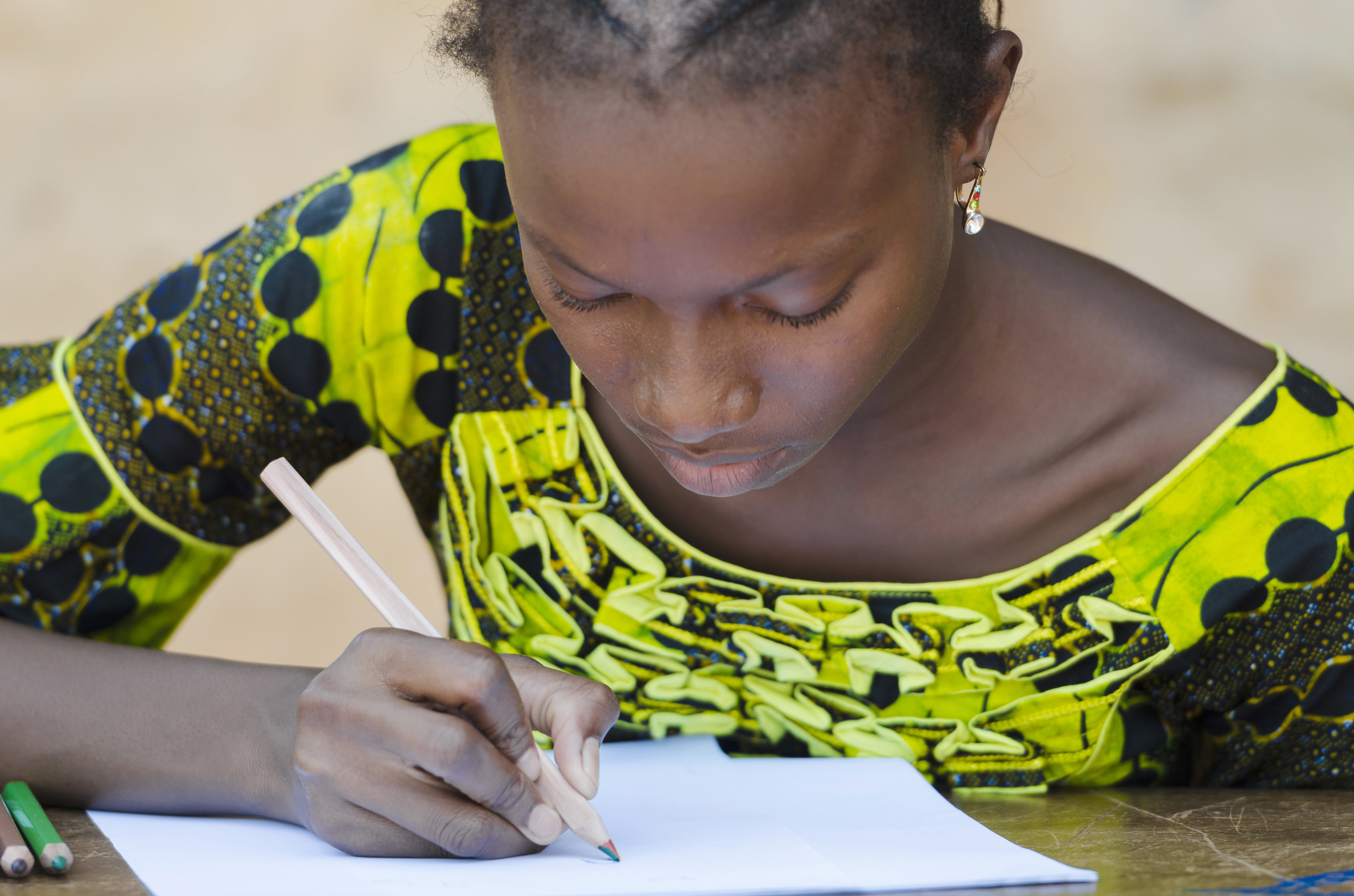 Close-Up African Ethnicity Teenage Woman Drawing with Colorful Pencils Mali